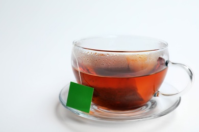 Hot tea in glass cup on white background