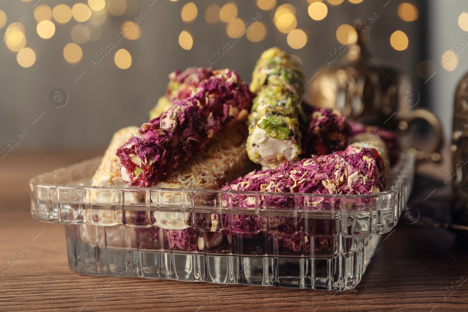 Photo of Turkish delight dessert on wooden table, closeup