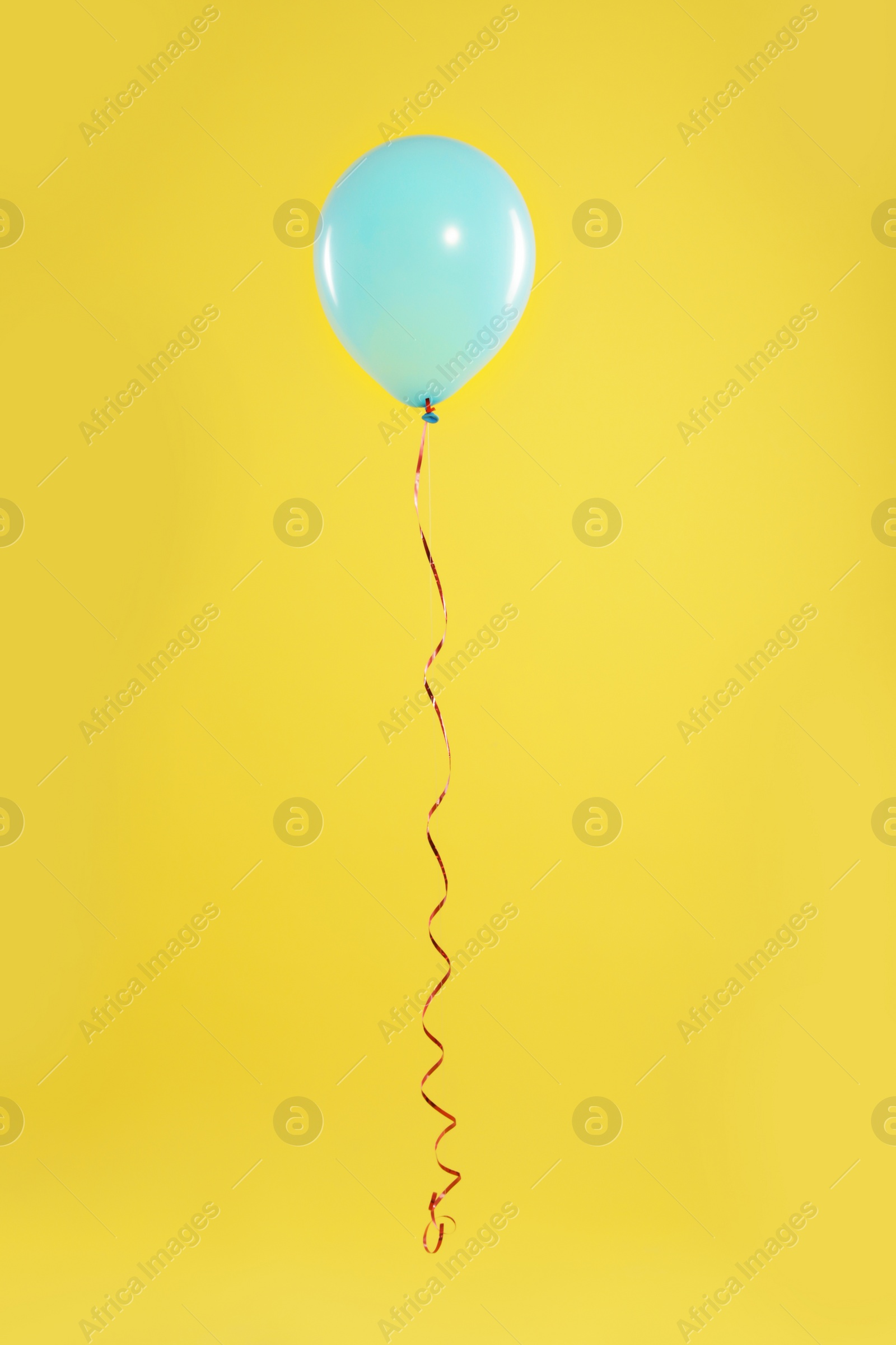 Photo of Bright balloon on color background. Celebration time