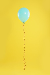 Photo of Bright balloon on color background. Celebration time