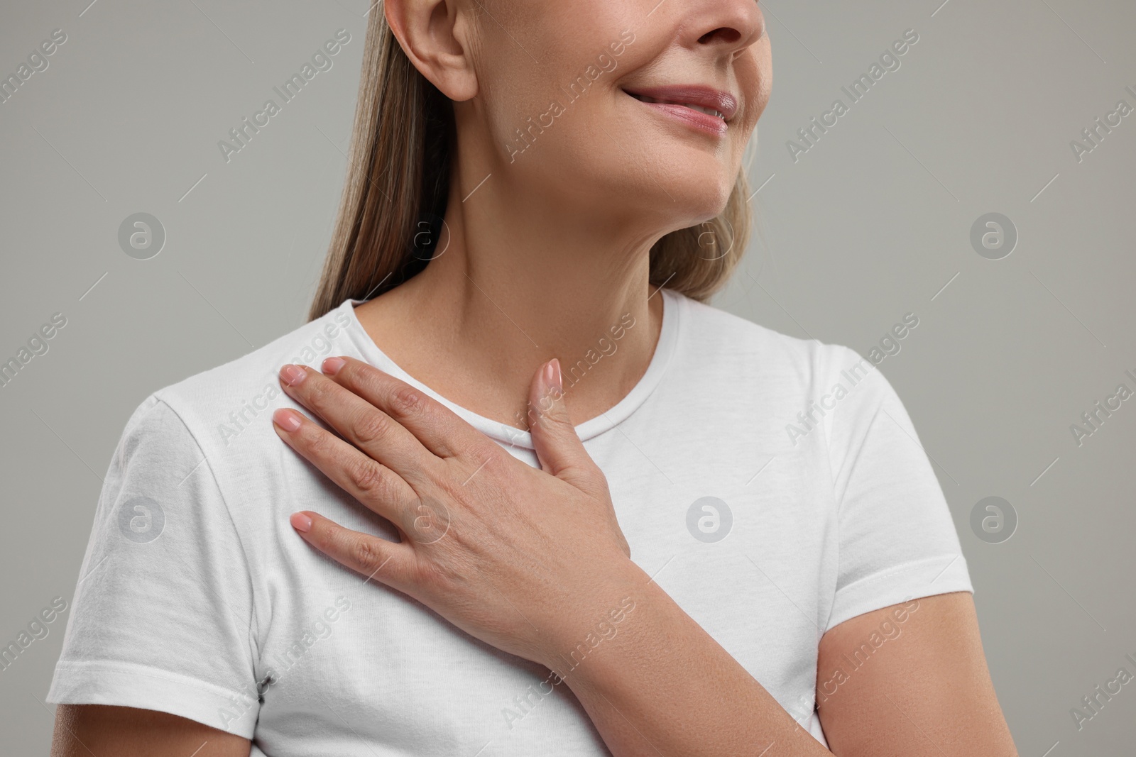 Photo of Mature woman with healthy skin on grey background, closeup