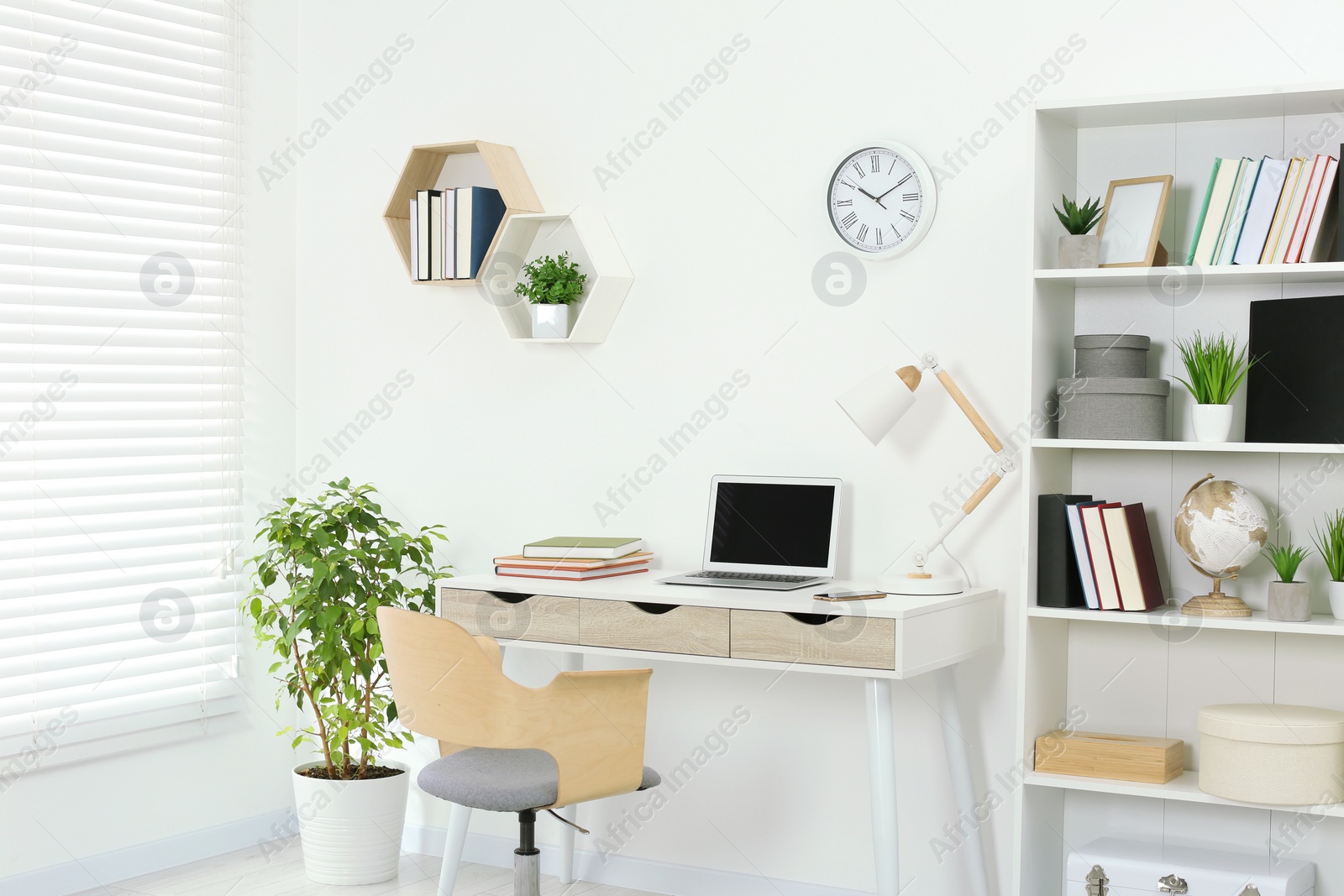 Photo of Beautiful workplace with comfortable desk and chair at home