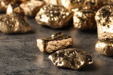 Pile of gold nuggets on grey table