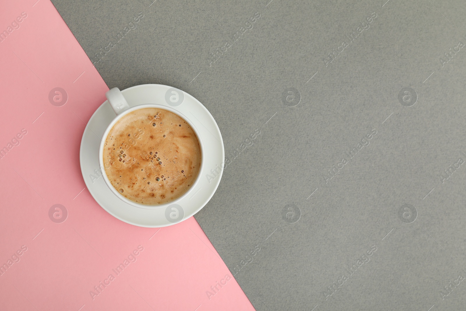 Photo of Cup of coffee on color background, top view. Space for text