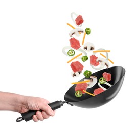 Image of Man tossing ingredients in wok on white background, closeup