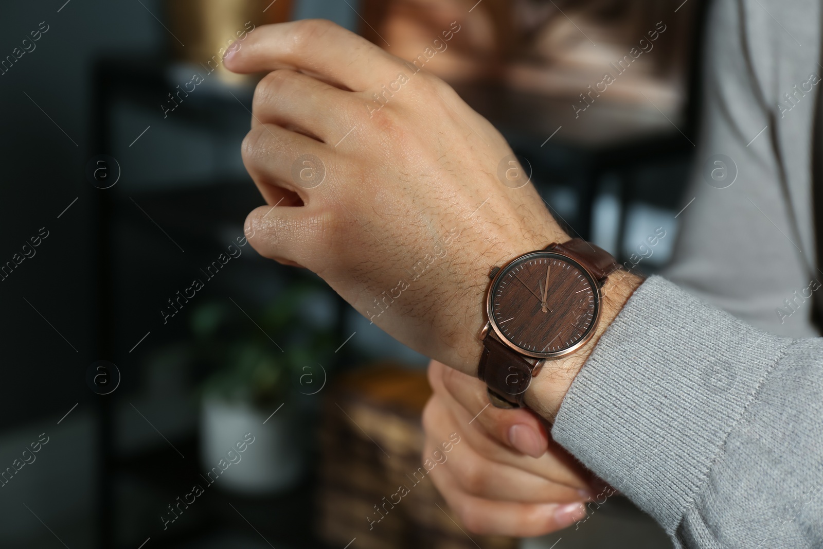 Photo of Man with luxury wrist watch indoors, closeup