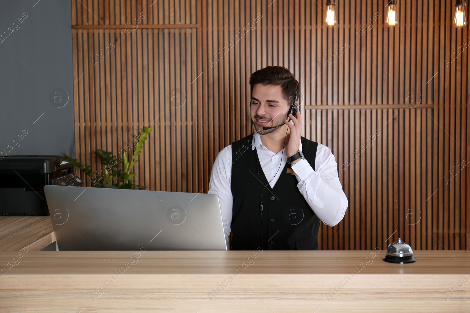 Photo of Portrait of receptionist with headset at desk in lobby