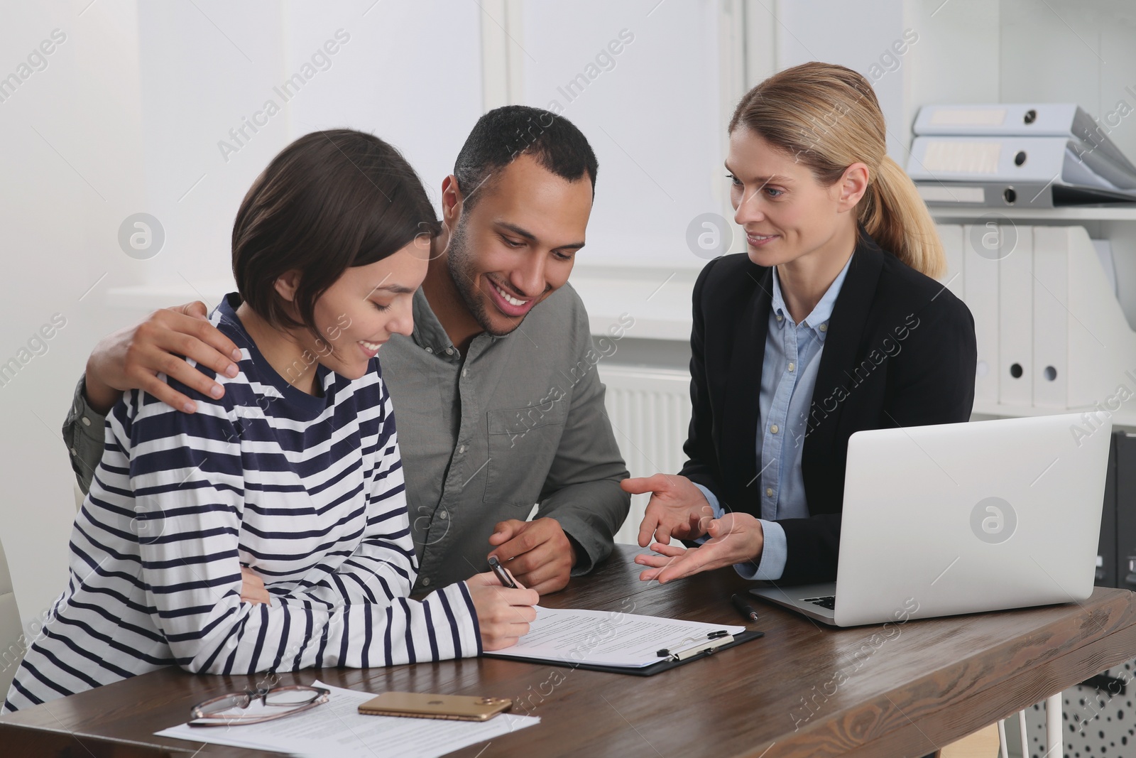 Photo of Couple consulting with professional notary in office