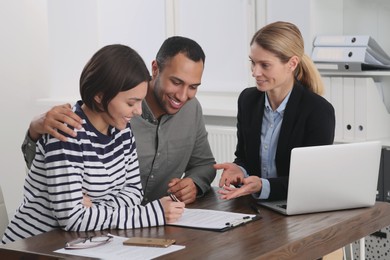 Couple consulting with professional notary in office