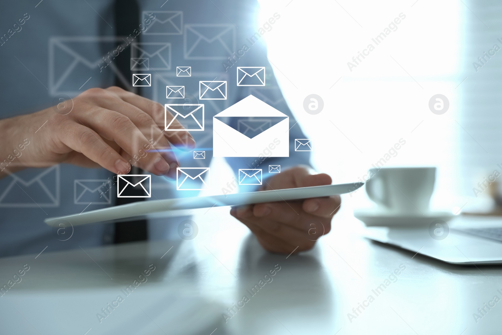 Image of Businessman sending emails at table in office, closeup