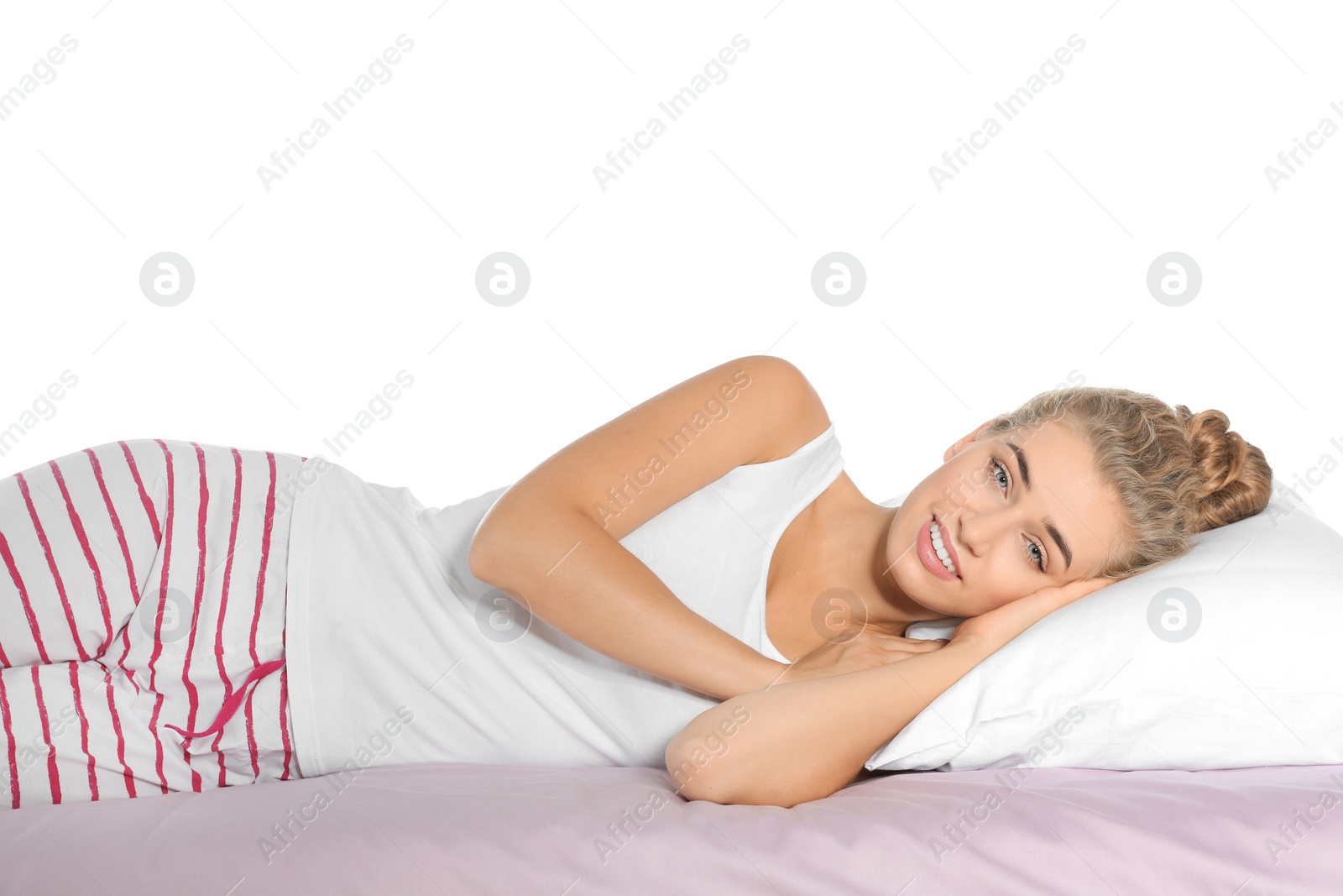 Photo of Beautiful woman lying with comfortable pillow on bed against white background