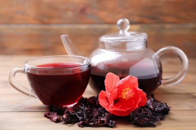 Photo of Composition with delicious hibiscus tea on wooden table