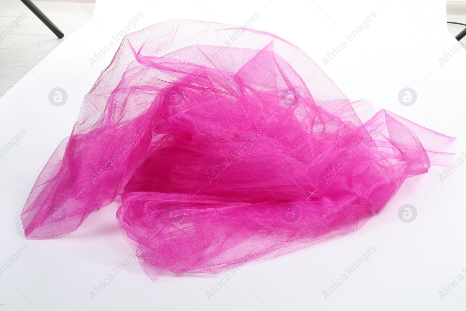 Photo of Beautiful pink tulle fabric on white background