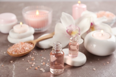 Photo of Beautiful spa composition with essential oil and candles on table