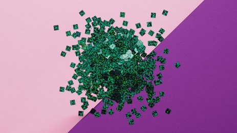 Photo of Pile of green sequins on colorful background, flat lay