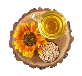 Photo of Sunflower, jug of oil and seeds on white background, top view