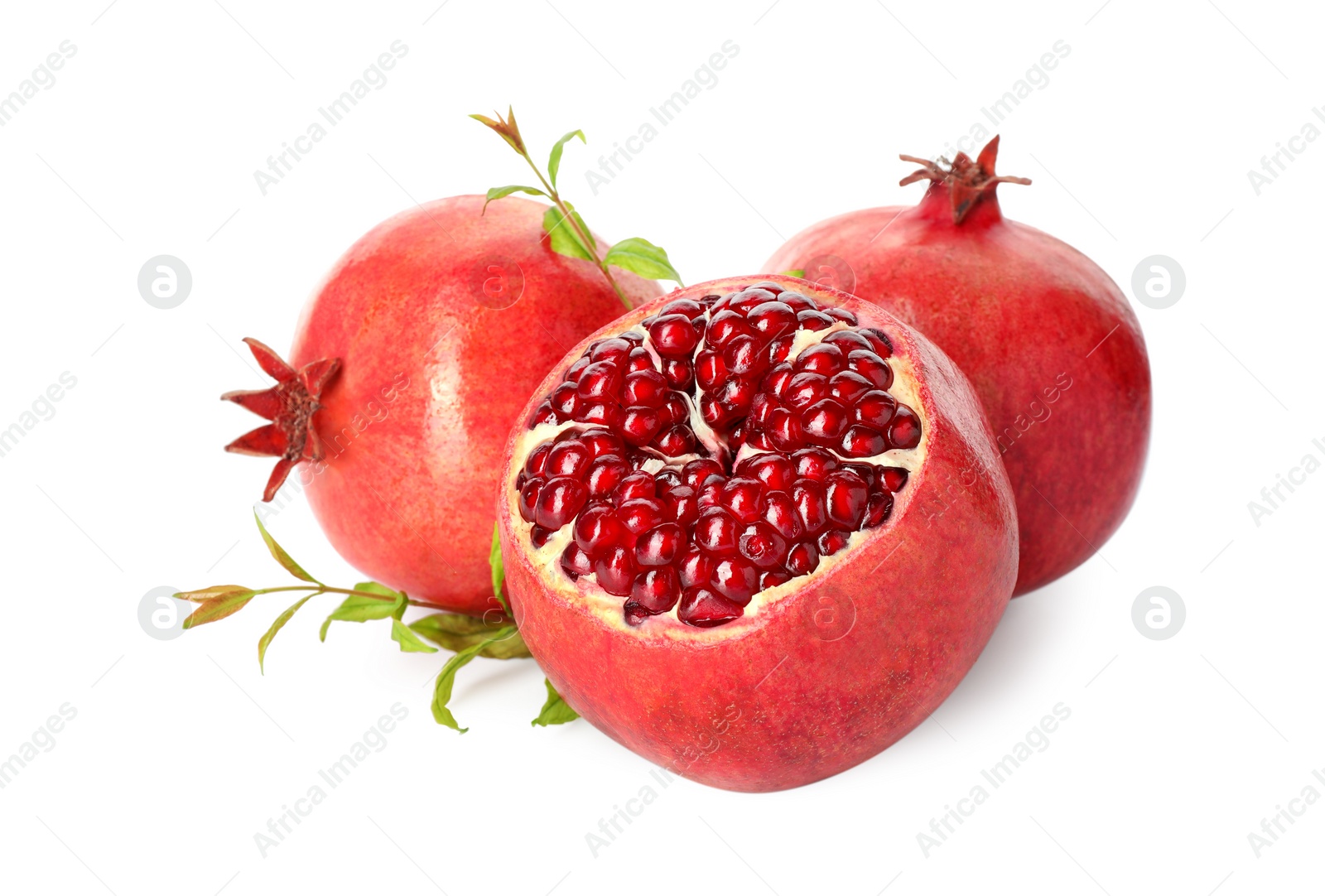 Photo of Fresh ripe pomegranates and green leaves isolated on white