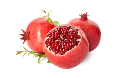 Photo of Fresh ripe pomegranates and green leaves isolated on white