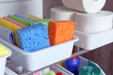 Photo of Different cleaning supplies in plastic boxes, closeup