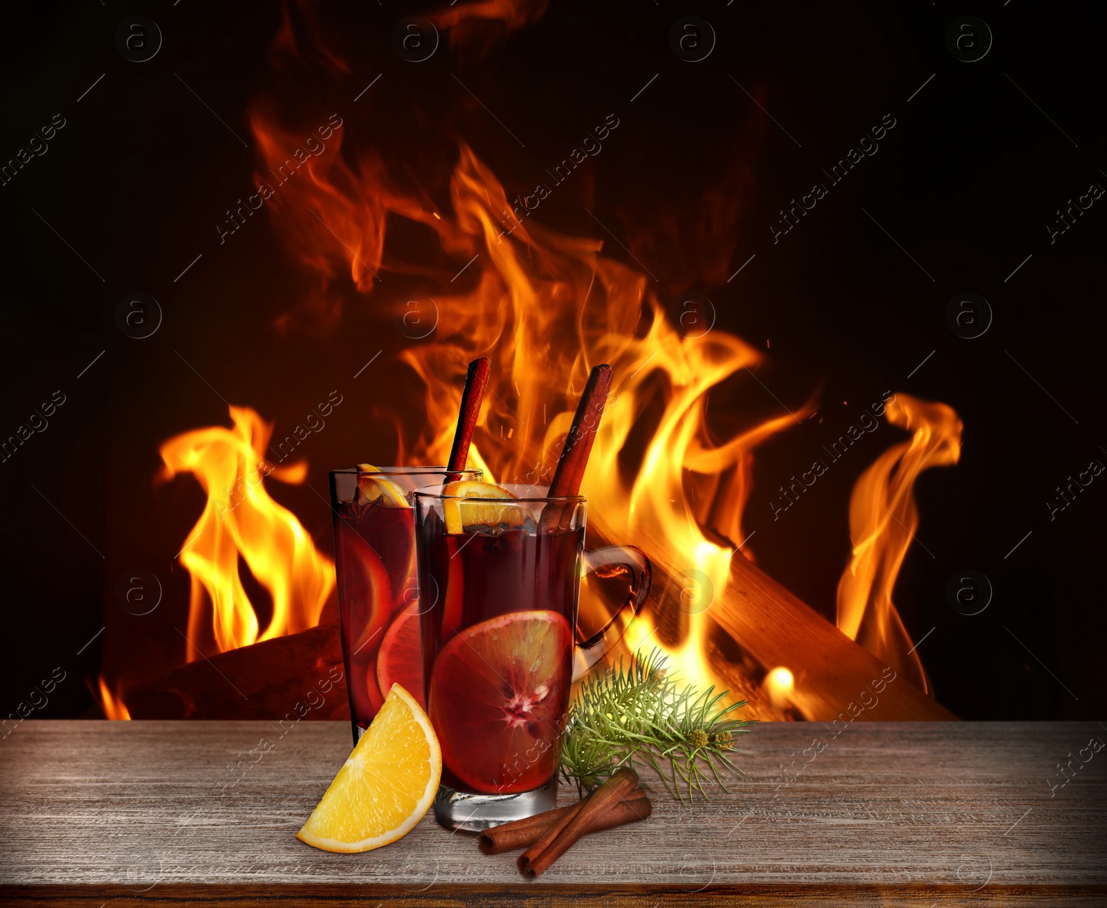 Image of Mulled wine on wooden table near fireplace
