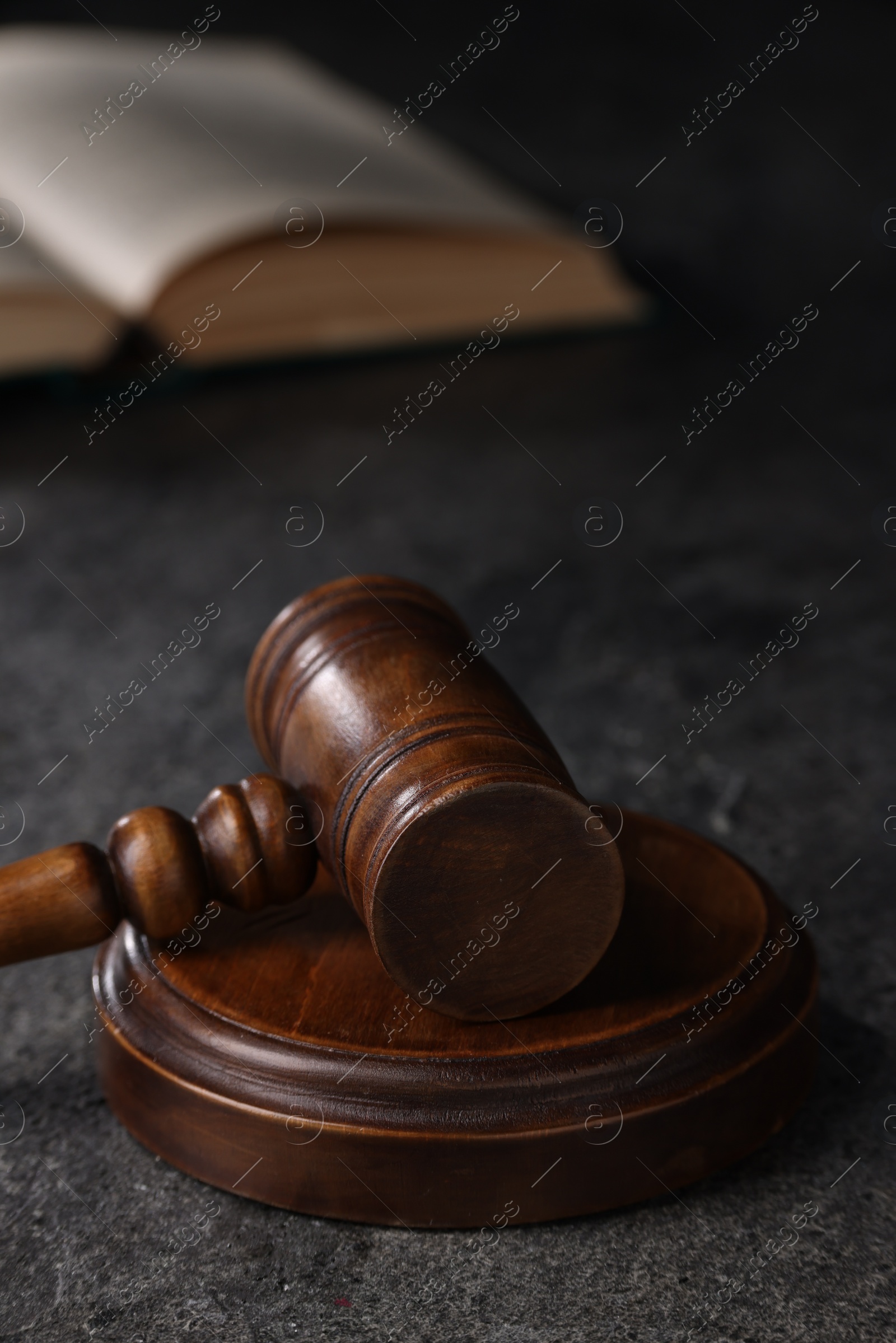 Photo of Law concept. Judge's gavel on grey textured table, closeup