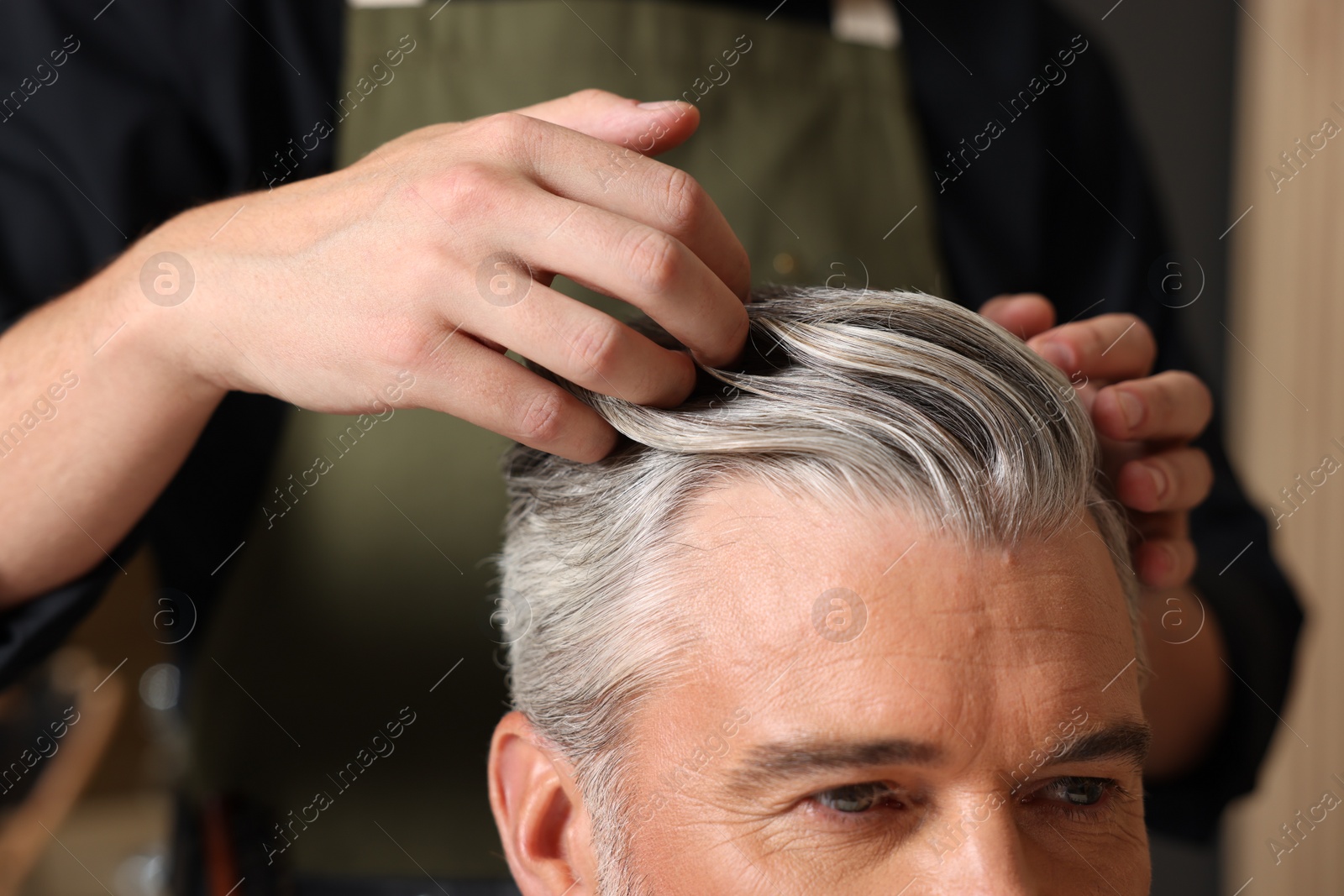 Photo of Hair styling. Professional hairdresser working with client in barbershop, closeup