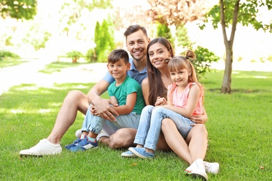 Happy family with children together in green park on sunny day