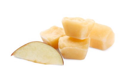 Photo of Frozen apple puree cubes and fruit on white background