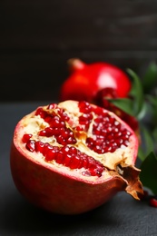 Photo of Fresh yummy pomegranate on dark table