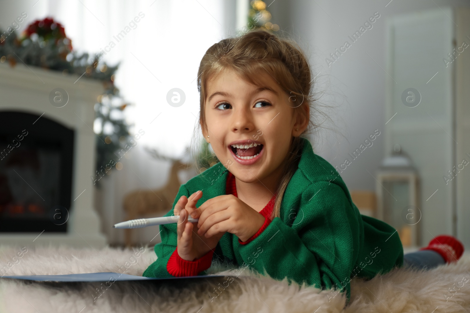 Photo of Cute child writing letter to Santa Claus at home. Christmas tradition