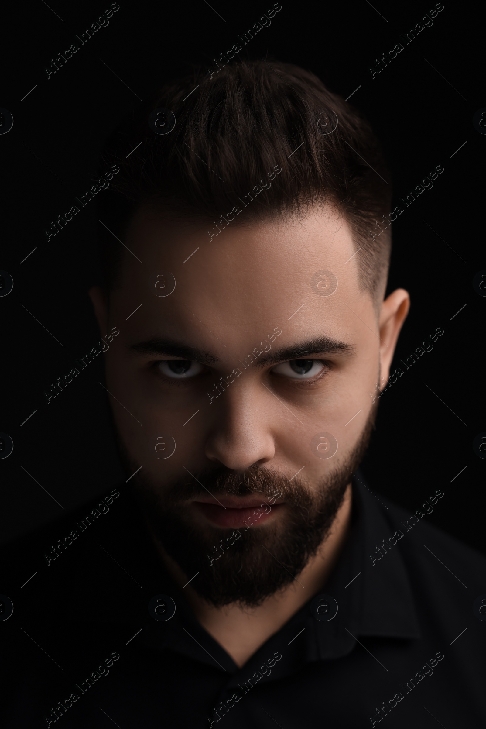 Photo of Evil eye. Man with scary eyes on black background