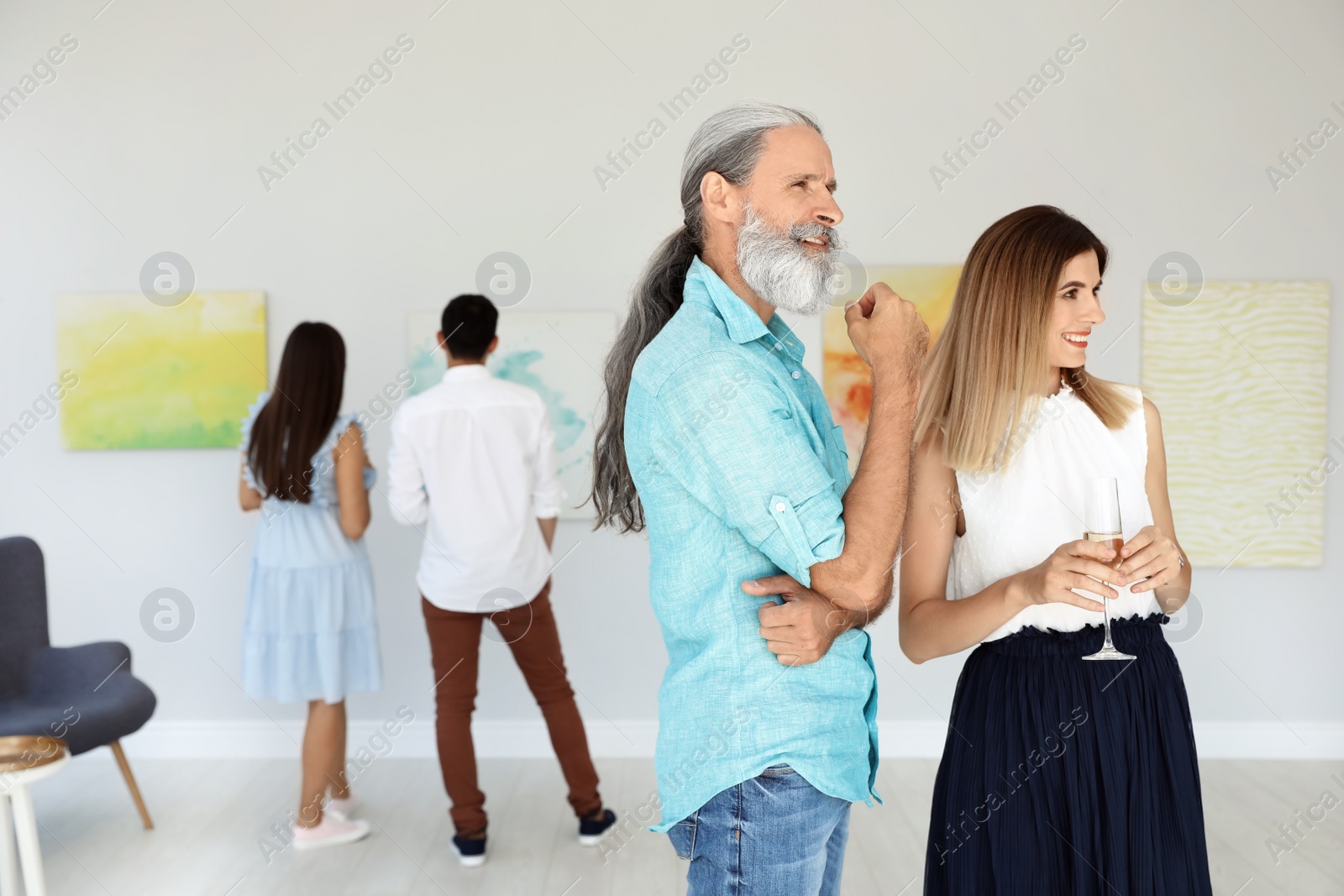 Photo of Senior man and woman at exhibition in art gallery