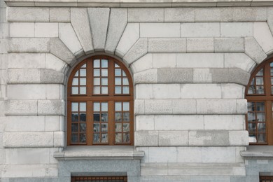 Photo of View of beautiful arched windows in building outdoors
