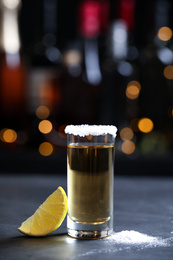 Photo of Mexican Tequila shot with lime slice and salt on bar counter