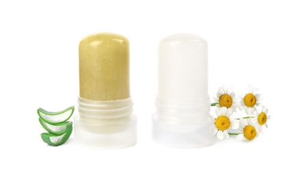 Natural crystal alum stick deodorants with chamomiles and aloe on white background