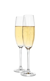 Photo of Glasses of sparkling champagne isolated on white