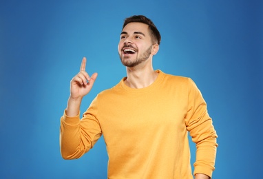 Portrait of handsome young man on color background