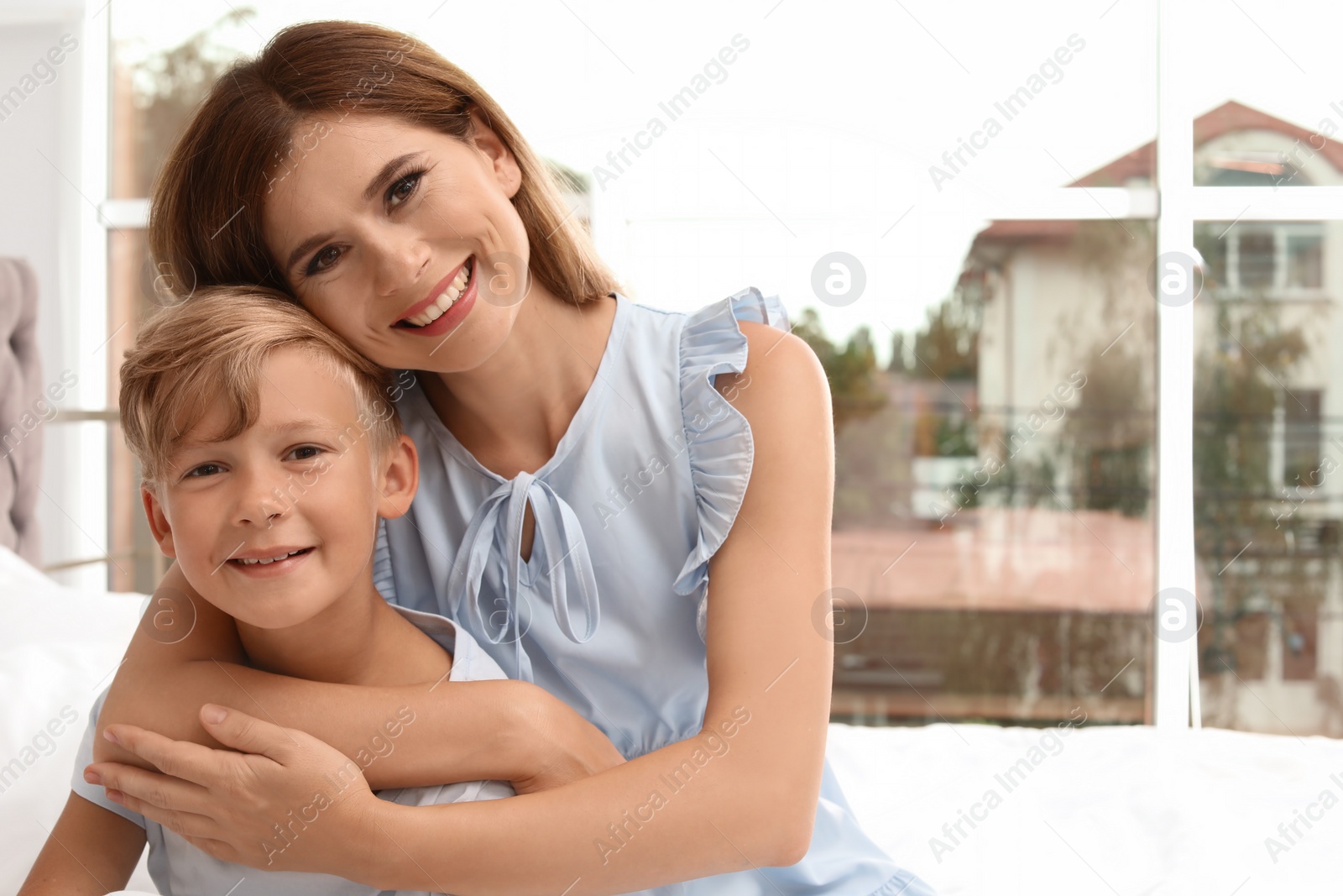 Photo of Portrait of mother and son in bedroom