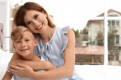 Portrait of mother and son in bedroom