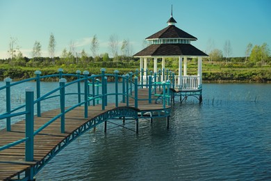 Photo of Beautiful view of bridge and gazebo on lake