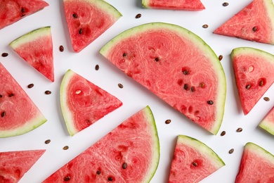 Slices of ripe watermelon on white background, flat lay