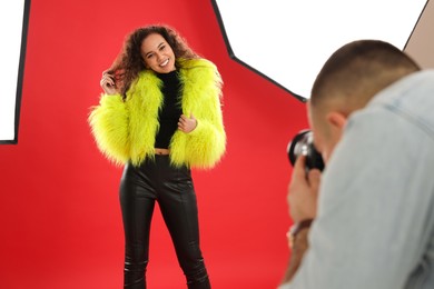 Beautiful African American model posing for professional photographer in studio