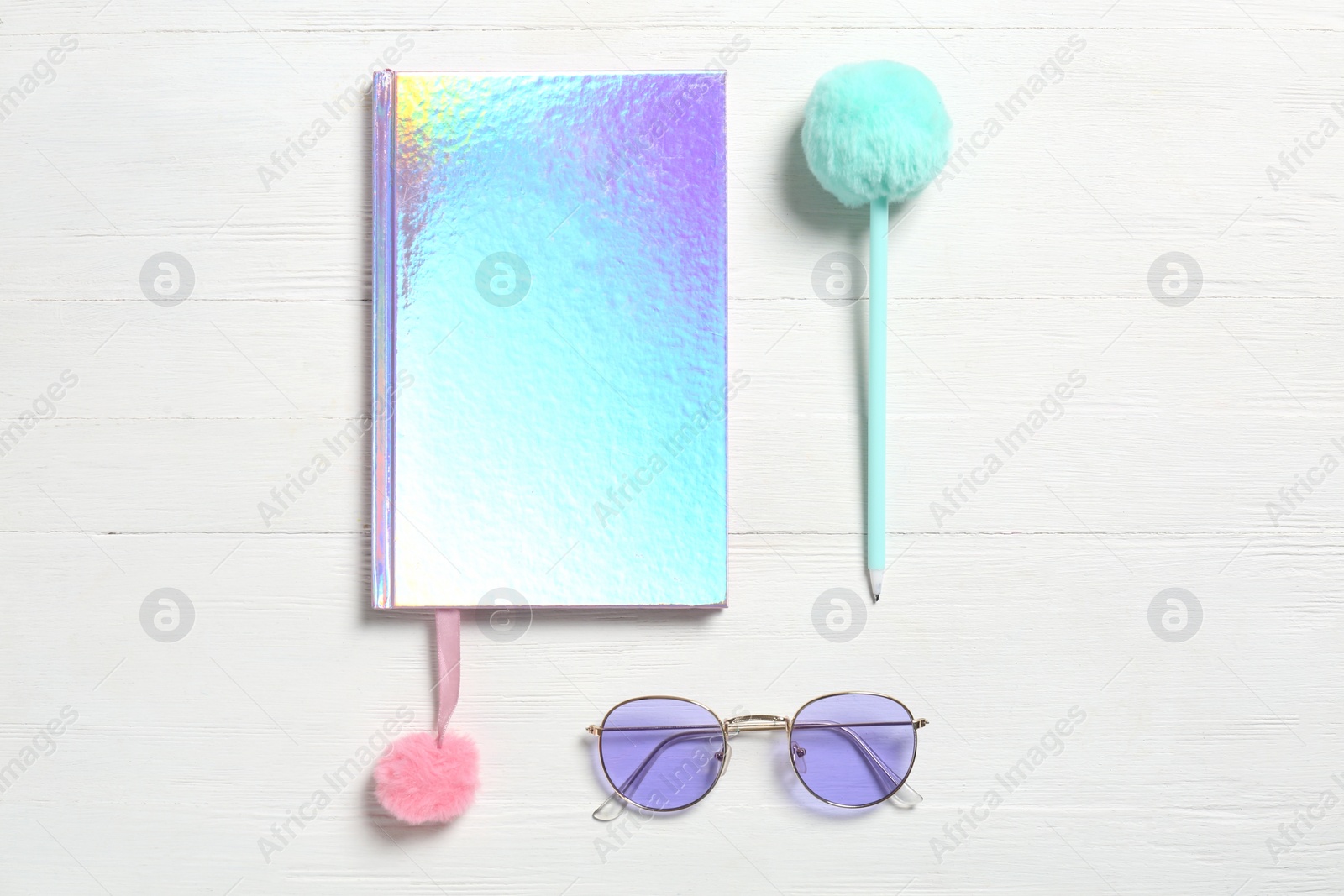 Photo of Stylish notebook, pen and eyeglasses on white wooden background, flat lay