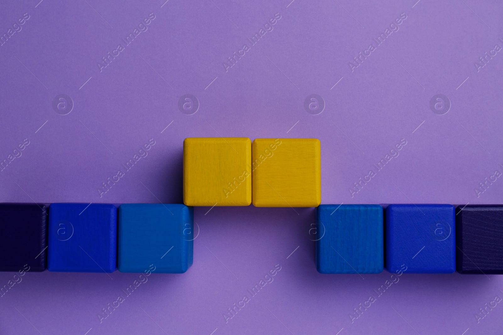 Photo of Bridge made of colorful blocks on violet background, flat lay. Connection, relationships and deal concept