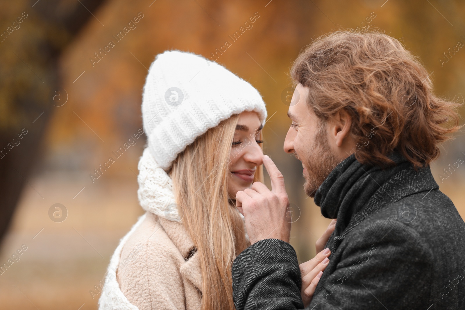 Photo of Young romantic couple in park on autumn day