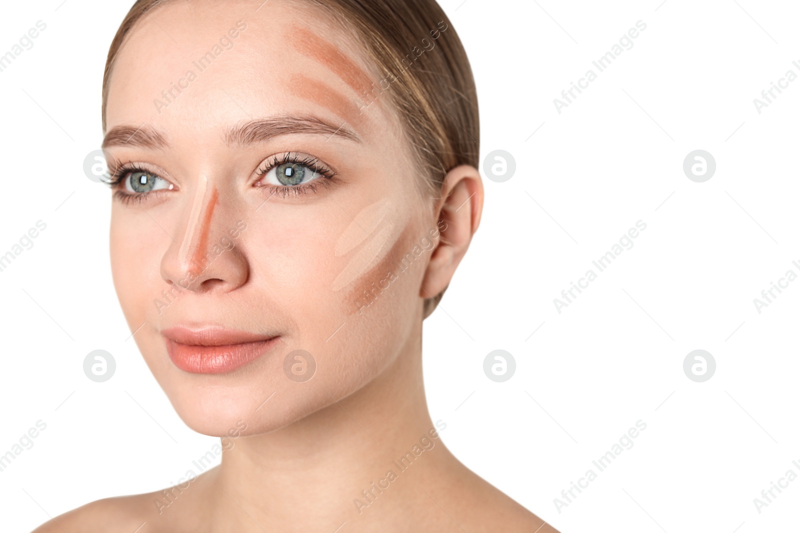 Photo of Portrait of beautiful young woman with makeup contouring smears on face against white background