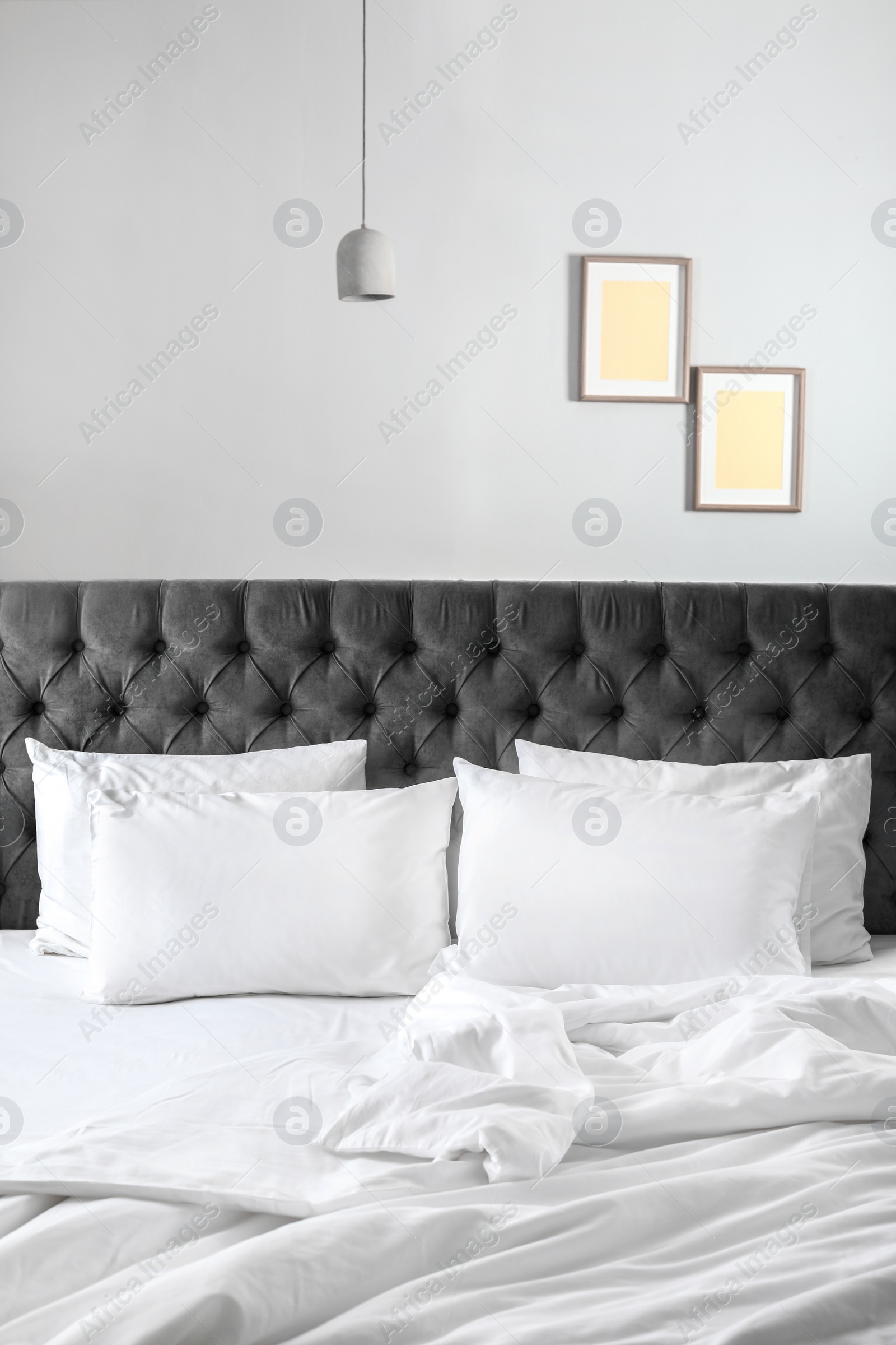 Photo of Comfortable bed with white linen and pillows at home