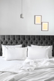 Photo of Comfortable bed with white linen and pillows at home