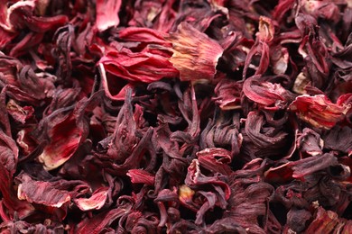 Photo of Dry hibiscus tea as background, closeup view