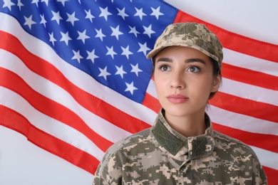 Photo of Female soldier in uniform and United states of America flag on white background